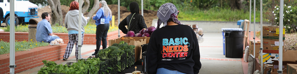 Person wearing Basic Needs Center Sweatshirt during food share event